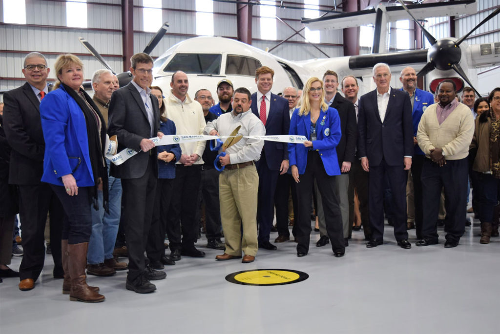 Image shows the ribbon cutting ceremony for the Berry Aviation maintenance hangar grand opening.